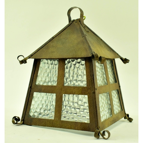 93 - An early 20th century Arts & Crafts hanging porch lantern lamp light. The light of copper constructi... 