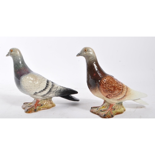 109 - Beswick - Two 20th Century porcelain china Beswick figures in the form of pigeons, both stood on a g... 