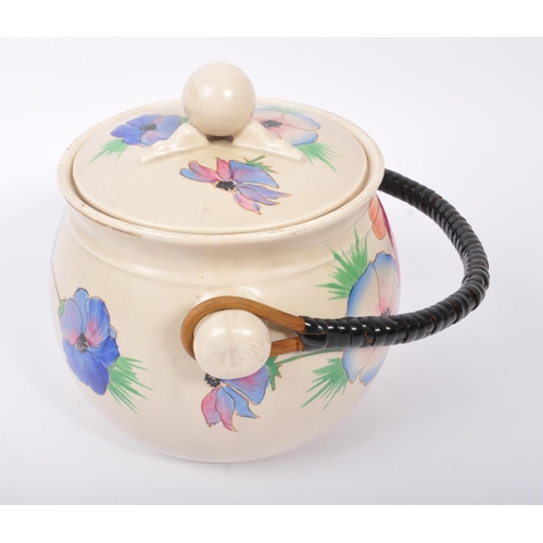 152 - Clarice Cliff - A retro 20th century ceramic pottery cauldron / handled pot. Having a twisted carry ... 