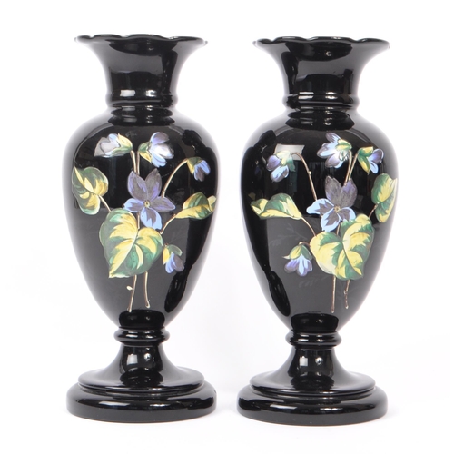 154 - Two early 20th Century Edwardian bohemian era black glass baluster vase with enamelled floral blue a... 