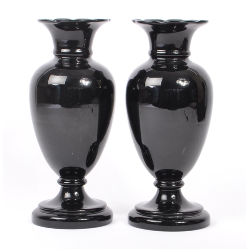 154 - Two early 20th Century Edwardian bohemian era black glass baluster vase with enamelled floral blue a... 