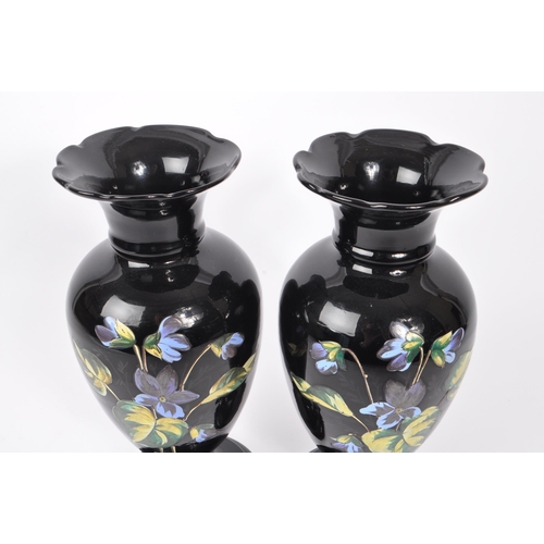 154 - Two early 20th Century Edwardian bohemian era black glass baluster vase with enamelled floral blue a... 