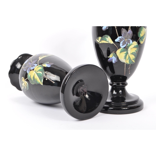 154 - Two early 20th Century Edwardian bohemian era black glass baluster vase with enamelled floral blue a... 