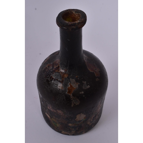 158 - An 18th century circa 1700s glass ship wreck wine bottle. The glass being of mallet type form and ir... 