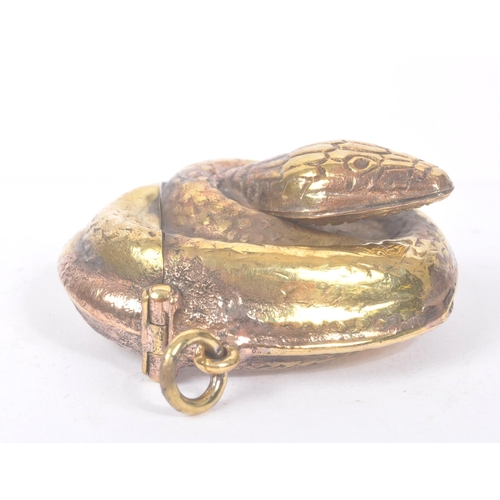 191 - A vintage 20th century gilt metal vesta case in the form of a curled snake. Measures approx. 4.4cm l... 