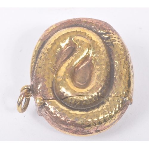 191 - A vintage 20th century gilt metal vesta case in the form of a curled snake. Measures approx. 4.4cm l... 