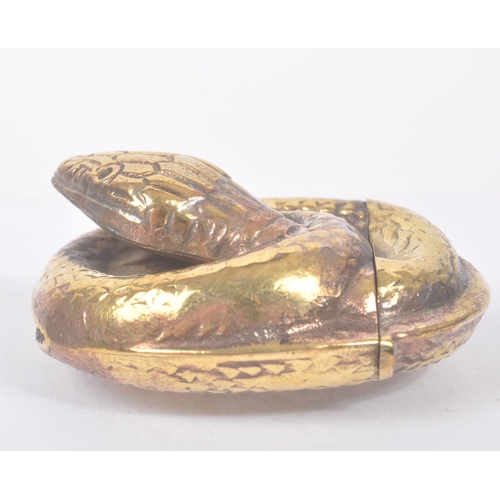 191 - A vintage 20th century gilt metal vesta case in the form of a curled snake. Measures approx. 4.4cm l... 