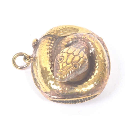 191 - A vintage 20th century gilt metal vesta case in the form of a curled snake. Measures approx. 4.4cm l... 