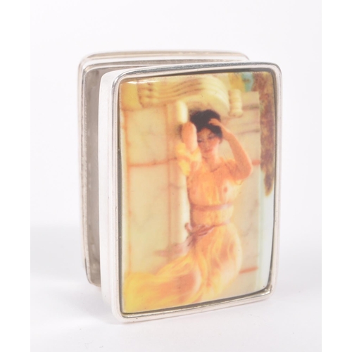 193 - A vintage 20th century silver pill box with semi nude enamelled lady to hinged lid. Measures approx.... 