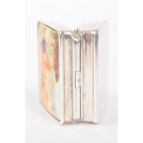 193 - A vintage 20th century silver pill box with semi nude enamelled lady to hinged lid. Measures approx.... 