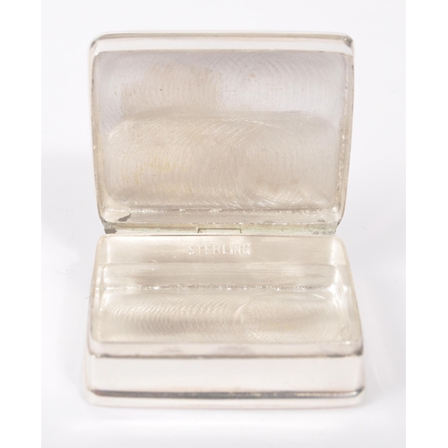 193 - A vintage 20th century silver pill box with semi nude enamelled lady to hinged lid. Measures approx.... 