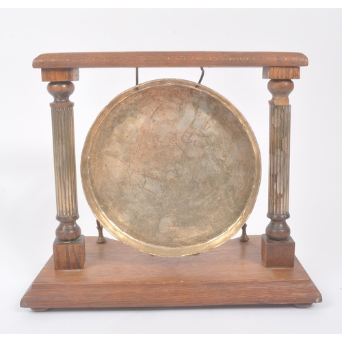 196 - A vintage 20th century brass Burmese table gong mounted on wooden base / frame. Having metal shield ... 