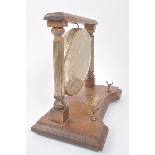 196 - A vintage 20th century brass Burmese table gong mounted on wooden base / frame. Having metal shield ... 