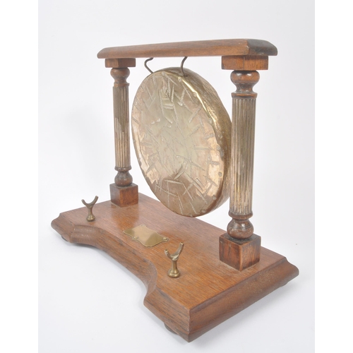 196 - A vintage 20th century brass Burmese table gong mounted on wooden base / frame. Having metal shield ... 