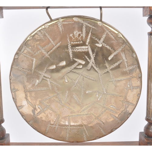 196 - A vintage 20th century brass Burmese table gong mounted on wooden base / frame. Having metal shield ... 