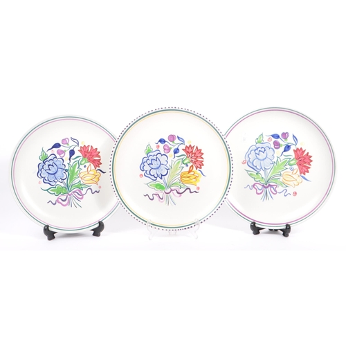 20 - Poole Pottery - A collection of three ceramic pottery display plates. With polychrome floral and fol... 