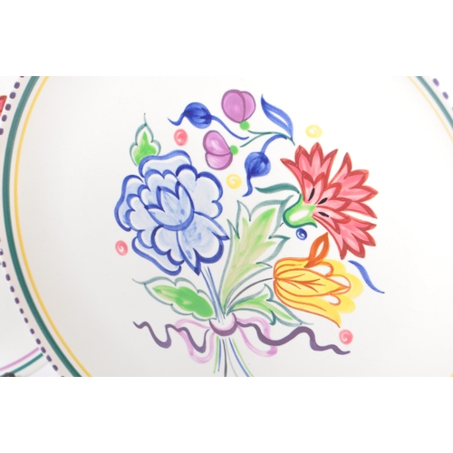 20 - Poole Pottery - A collection of three ceramic pottery display plates. With polychrome floral and fol... 