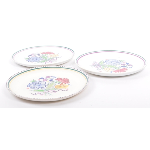 20 - Poole Pottery - A collection of three ceramic pottery display plates. With polychrome floral and fol... 