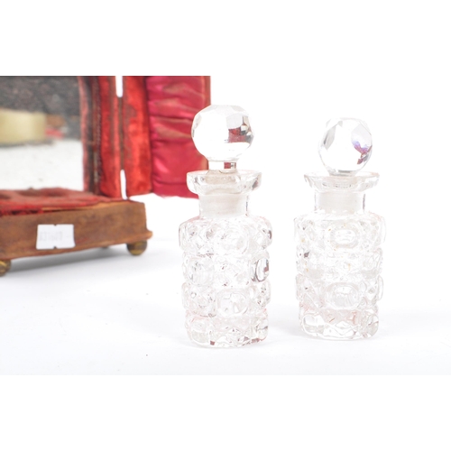 200 - A pair of Victorian / early 20th Century cased glass perfume / scent bottles. Having cut glass clear... 