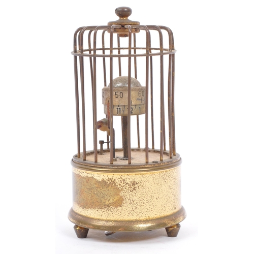 201 - A mid 20th century circa 1950s  clock modelled as a bird in a brass cage. A brass case cage clock wi... 