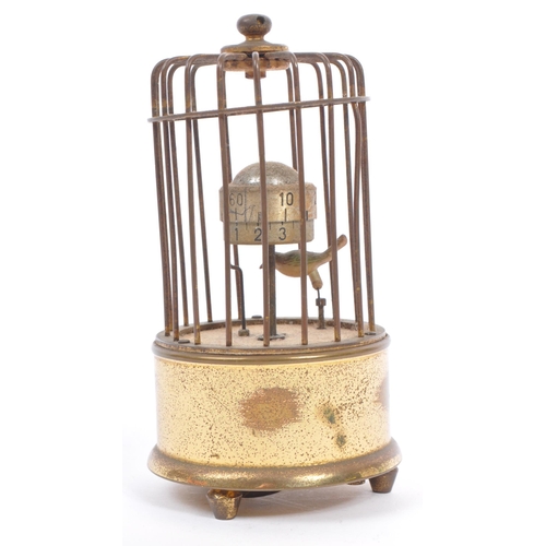 201 - A mid 20th century circa 1950s  clock modelled as a bird in a brass cage. A brass case cage clock wi... 