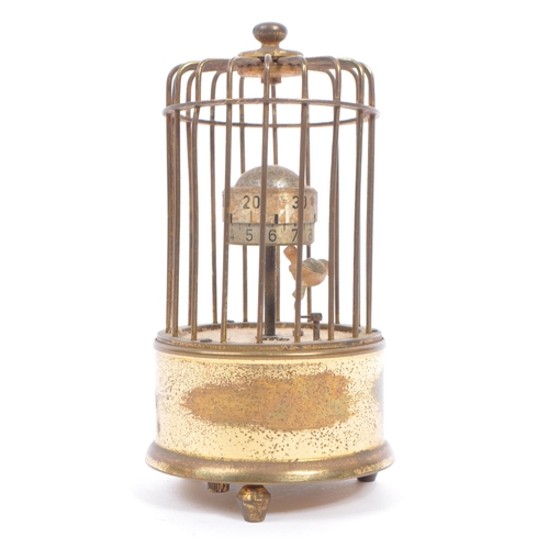 201 - A mid 20th century circa 1950s  clock modelled as a bird in a brass cage. A brass case cage clock wi... 