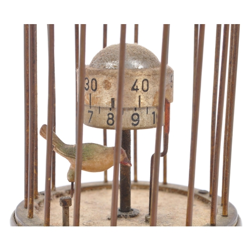 201 - A mid 20th century circa 1950s  clock modelled as a bird in a brass cage. A brass case cage clock wi... 