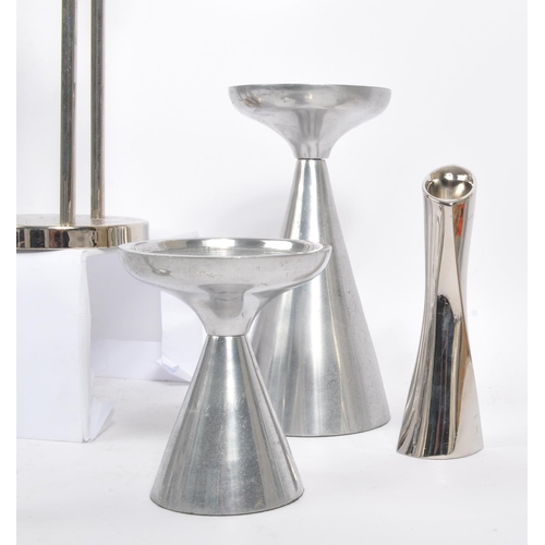 202 - A collection of 1980s and later late 20th century stainless steel candle holders. The lot to include... 