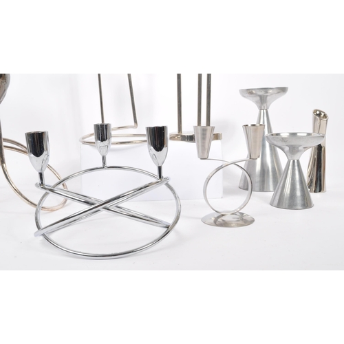 202 - A collection of 1980s and later late 20th century stainless steel candle holders. The lot to include... 