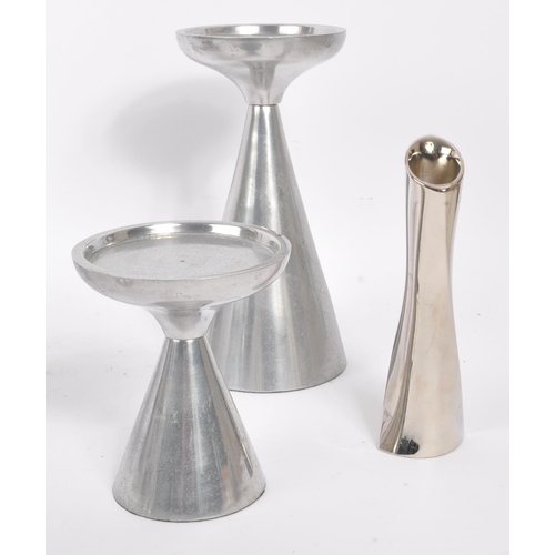 202 - A collection of 1980s and later late 20th century stainless steel candle holders. The lot to include... 