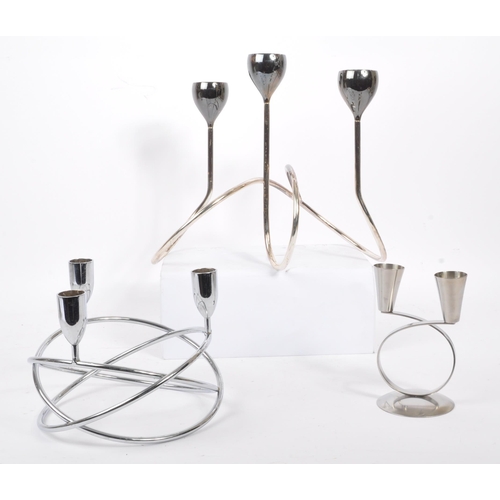 202 - A collection of 1980s and later late 20th century stainless steel candle holders. The lot to include... 