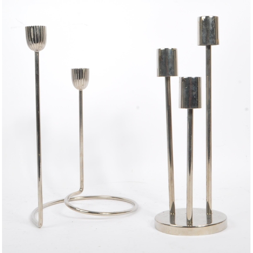 202 - A collection of 1980s and later late 20th century stainless steel candle holders. The lot to include... 