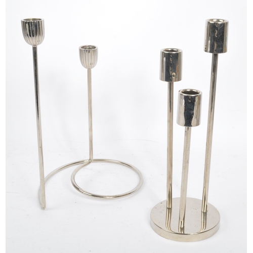 202 - A collection of 1980s and later late 20th century stainless steel candle holders. The lot to include... 