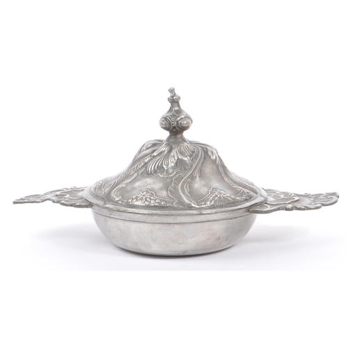 204 - A 19th Century continental pewter lidded art nouveau pot with raised floral and leaf design and fini... 