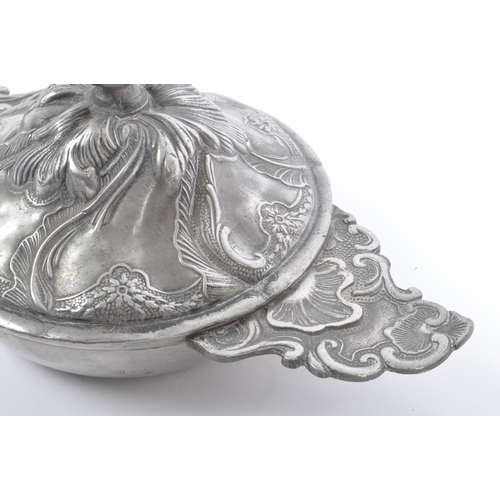 204 - A 19th Century continental pewter lidded art nouveau pot with raised floral and leaf design and fini... 