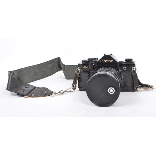 206 - Canon - A 20th century circa 1980s Canon A-1 35mm SLR camera and lens. The camera having a black bod... 