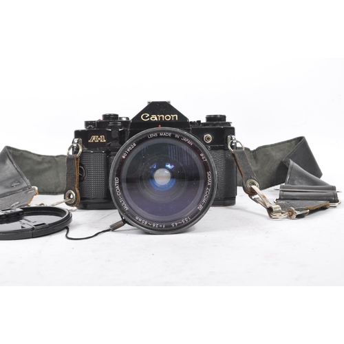 206 - Canon - A 20th century circa 1980s Canon A-1 35mm SLR camera and lens. The camera having a black bod... 