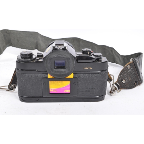 206 - Canon - A 20th century circa 1980s Canon A-1 35mm SLR camera and lens. The camera having a black bod... 