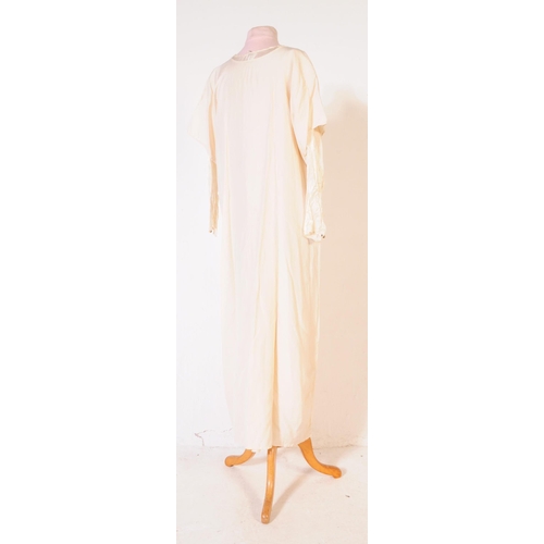 211 - An early 20th Century 1920s vintage ivory coloured silk wedding dress, comprising of both under and ... 