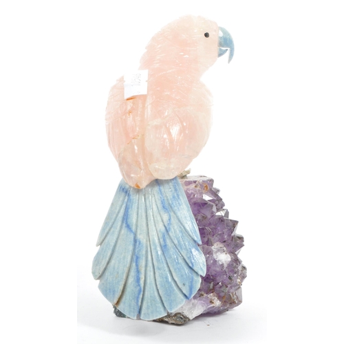 224 - A carved rose quartz parrot perched upon an amethyst crystal geode with textured white metal . Measu... 