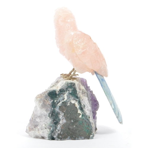 224 - A carved rose quartz parrot perched upon an amethyst crystal geode with textured white metal . Measu... 