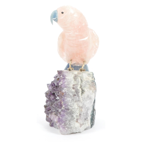 224 - A carved rose quartz parrot perched upon an amethyst crystal geode with textured white metal . Measu... 