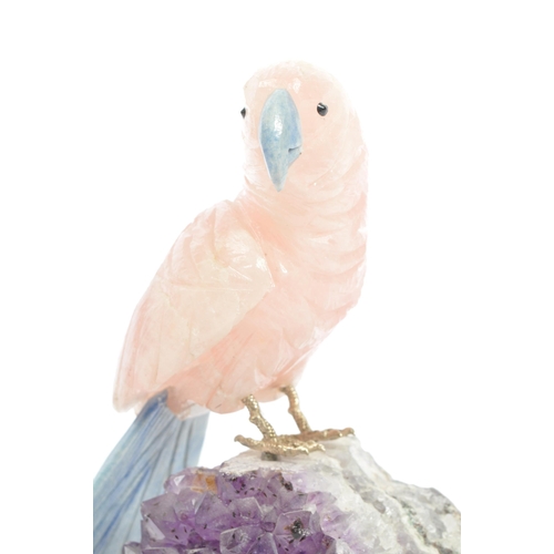 224 - A carved rose quartz parrot perched upon an amethyst crystal geode with textured white metal . Measu... 