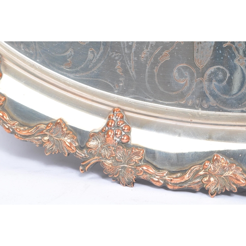 225 - An early 20th century white metal silver engraved serving / butlers tray. Of oval form with foliate ... 