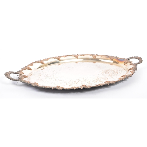 225 - An early 20th century white metal silver engraved serving / butlers tray. Of oval form with foliate ... 