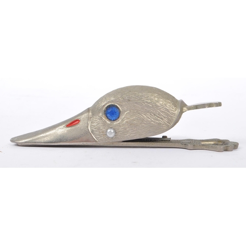 231 - A retro 1980s stainless steel paper clip modelled as a duck head. With blue glass inset eyes and fin... 