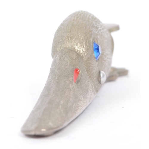 231 - A retro 1980s stainless steel paper clip modelled as a duck head. With blue glass inset eyes and fin... 