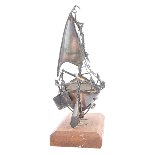 236 - A mid 20th Century scratch built white metal hand made model sailing boat. Having a single mast with... 