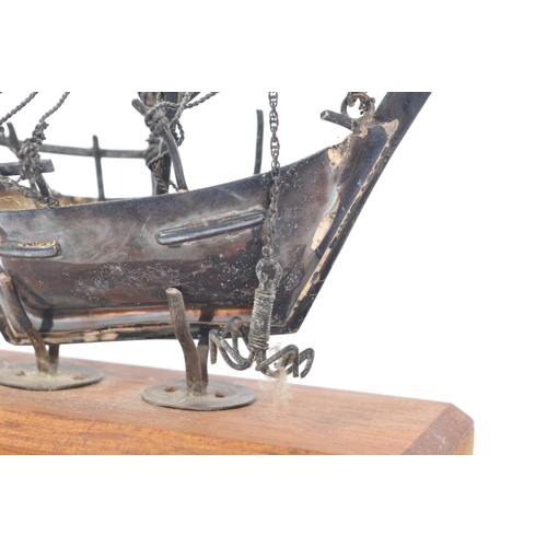 236 - A mid 20th Century scratch built white metal hand made model sailing boat. Having a single mast with... 