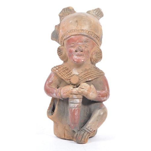 243 - A 20th century South American clay figure, possibly Ecuadorian. Tribal figure playing drum in seated... 